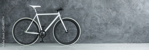 Fototapeta White bicycle against concrete wall