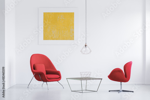 Red armchairs at designer table