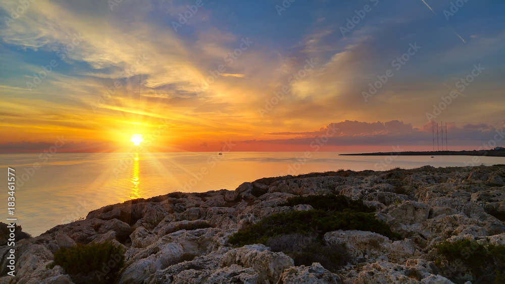Cyprus beautiful sunrise with rocks and cloudy colorful sky, natural sea panoramic background