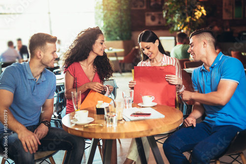 Group of young people meeting in a cafe after shopping