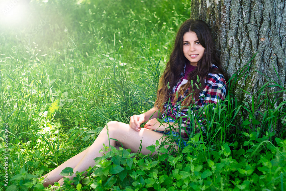 Beautiful girl is stylish and fashionably dressed in the park Beautiful girl is stylish and fashionably dressed in the park