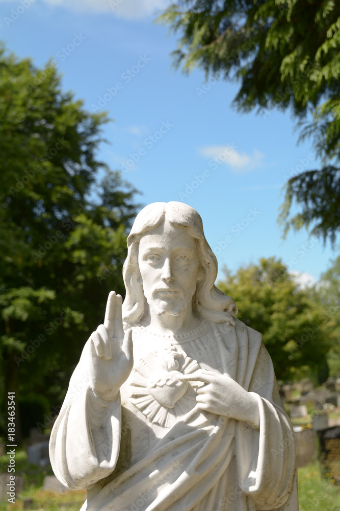 Statue of Jesus Christ on grave in cemetery