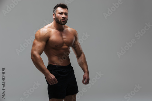 Portrait of a confident serious shirtless male bodybuilder