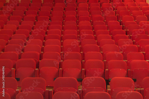 View of an empty theatre with old red seats