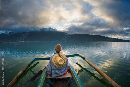 girl traveler boating on a lake © Evgenii