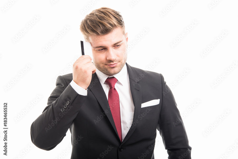 Handsome manager thinking holding credit card Handsome manager thinking holding credit card