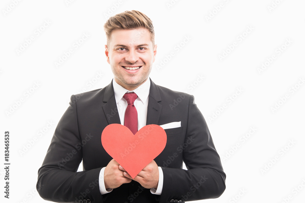 Handsome manager holding red heart shape and smiling