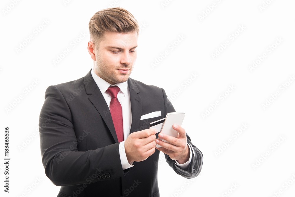 Handsome manager paying with smartphone and card Handsome manager paying with smartphone and card