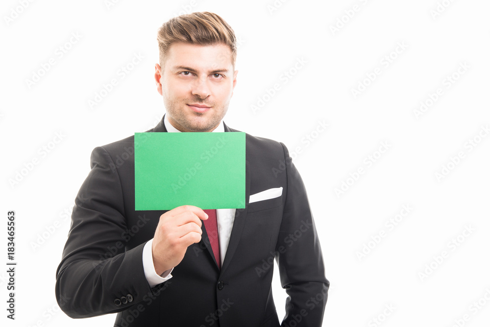 Handsome manager showing blank green cardboard Handsome manager showing blank green cardboard
