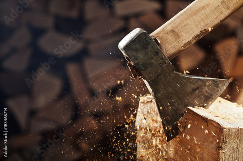 Chopping wood with axe - closeup on flying wooden chips - copy space