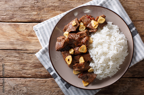 Philippine food: Salpicao beef with garlic and rice closeup on a plate. Horizontal top view