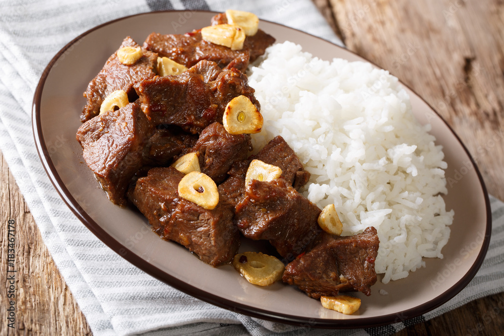 spicy beef salpicao with garlic and rice closeup on a table. horizontal spicy beef salpicao with garlic and rice closeup on a table. horizontal