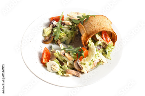 Fresh vegan vegetable salad with mushroom, quail egg, arugula, tomato, cucumber and bread toast. Round plate. Isolated on white