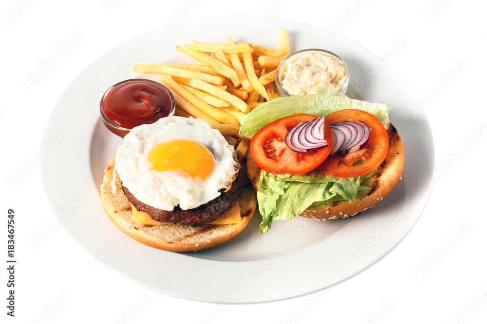 Opened cheese burger with grilled cutlet, cheese, scrambled egg with yolk, tomato, onion, two kind of sauces and salad, as well as roasted potatoes On a round plate. Isolated on white Opened cheese burger with grilled cutlet, cheese, scrambled egg with yolk, tomato, onion, two kind of sauces and salad, as well as roasted potatoes On a round plate. Isolated on white