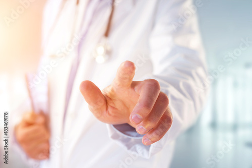 Doctor pointing his finger at the hospital