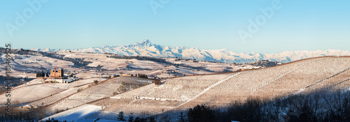 Panoramic view of Castle of Grinzane and mount Viso in northern italy, winter, langhe region, piedmont