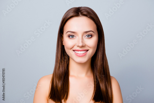 Close up portrait of beautiful pretty cute lovely smiling woman with perfect smooth flawless skin, isolated on grey background