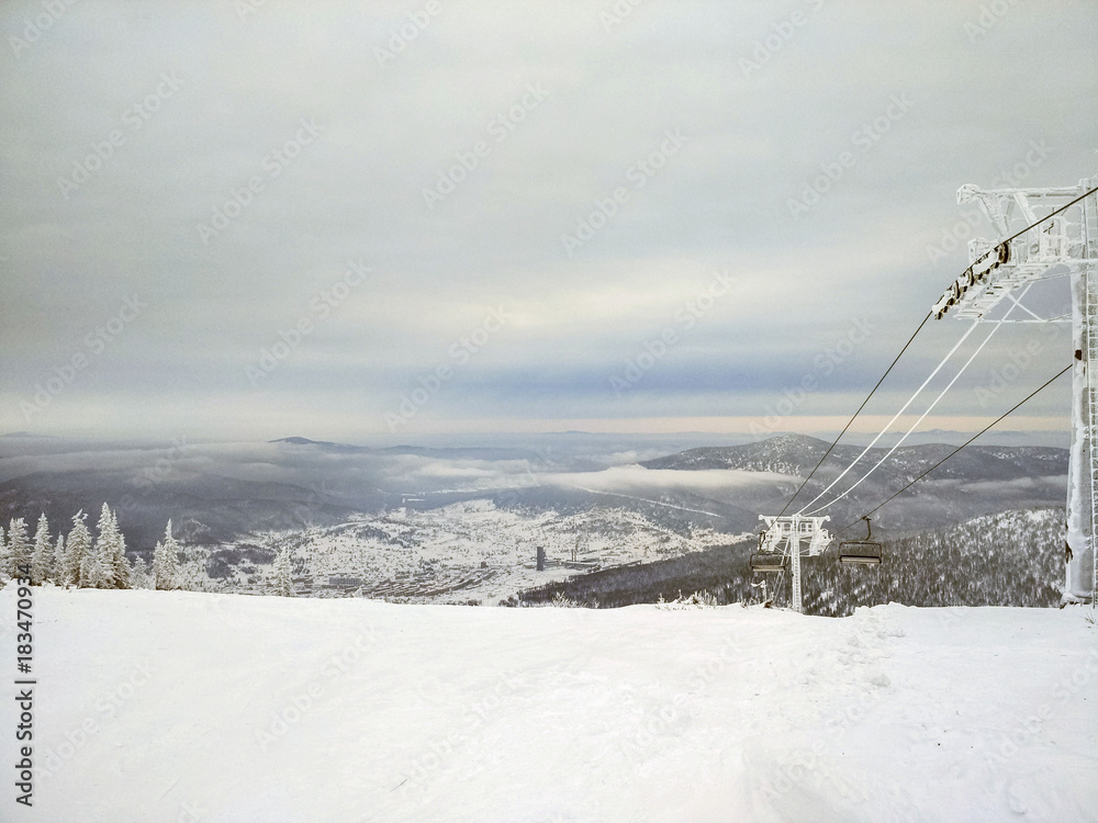 Panorama of ski resort, slope. Cold weather, the supports of the cable car in the ice. Panorama of ski resort, slope. Cold weather, the supports of the cable car in the ice.