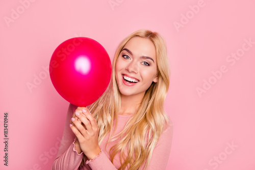 Close up portrait of beauty, cute girl with red air balloons laughing over pink background, beautiful Happy Young woman on birthday holiday party, joyful model having fun