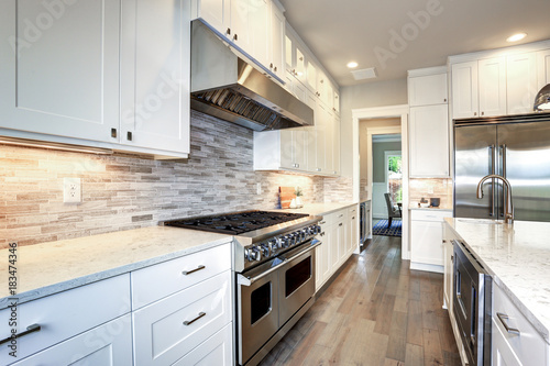 Luxury white kitchen with large kitchen island.