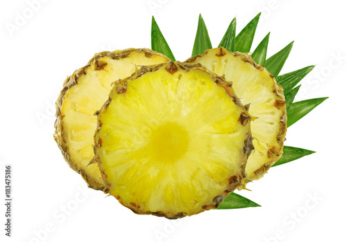 three slices of pineapple with leaves isolated on white