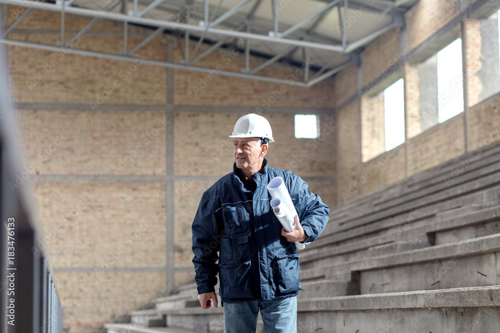 Senior construction manager controlling building site.