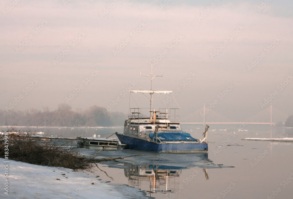 Fototapeta premium Boat on river in winter