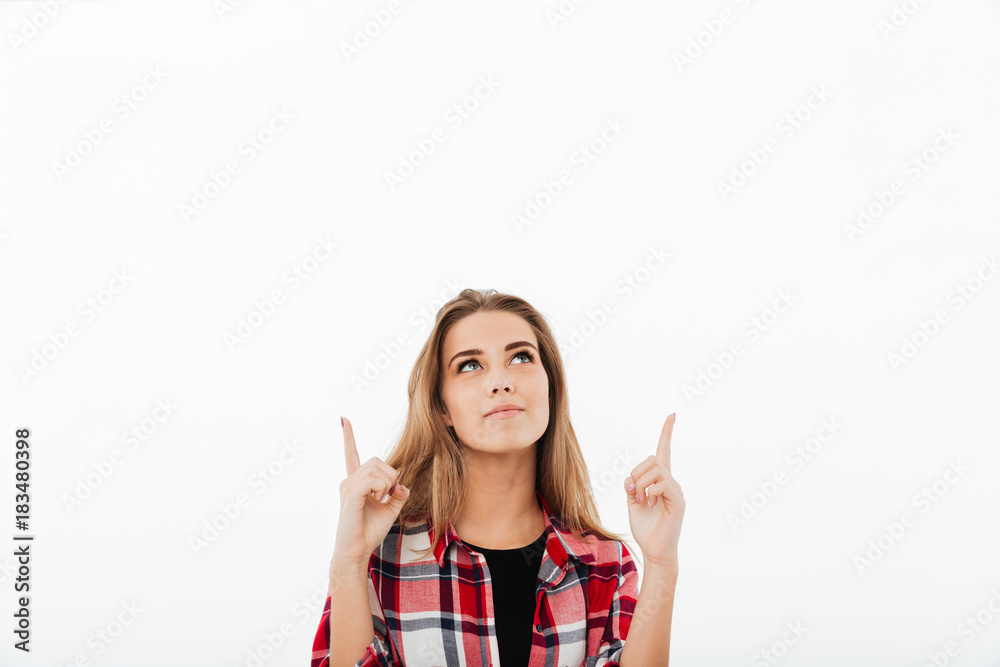 Portrait of a young smiling girl in plaid shirt