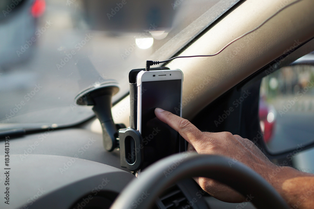 Male hand search data from mobile phone in the car. Male hand search data from mobile phone in the car.