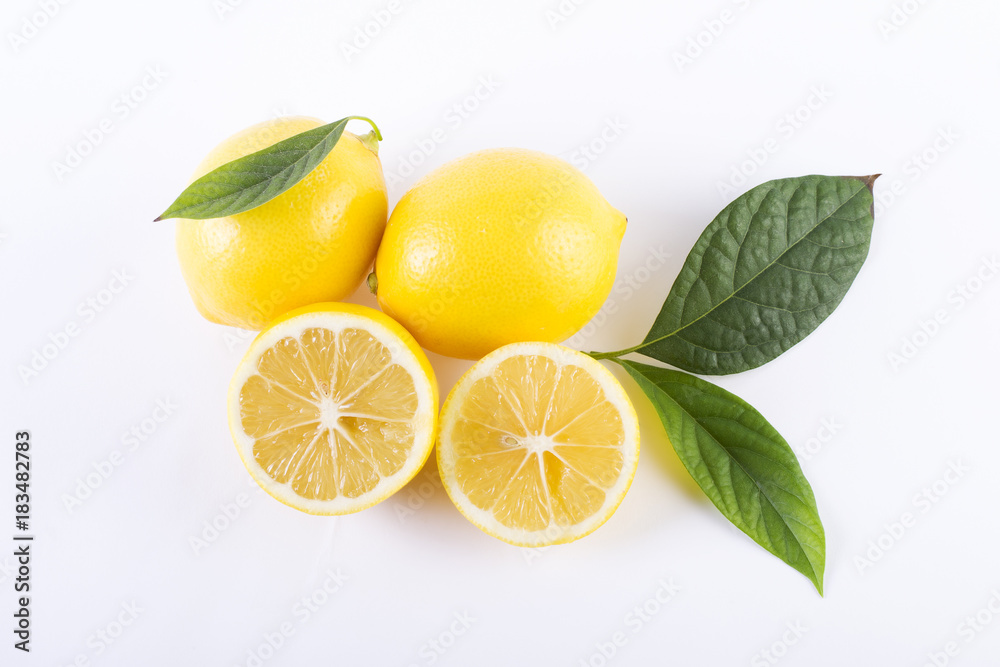 Naklejka Lemons with leaves on a white background. Fresh lemons on a white background.