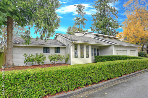 Photography Nicely remodeled home exterior with boxwood hedge