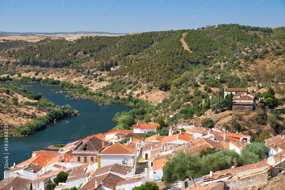 View of Guadiana river bend and residential houses of Mertola city on the ripe. Mertola. Portugal