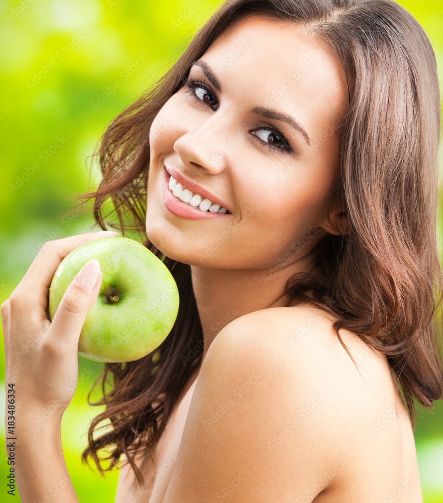 Young happy smiling woman with apple, outdoors Young happy smiling woman with apple, outdoors