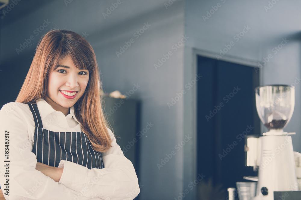 small business owner standing at counter in coffee shop. female barista wearing apron smiling at bar in cafe. food service, restaurant concept. small business owner standing at counter in coffee shop. female barista wearing apron smiling at bar in cafe. food service, restaurant concept.
