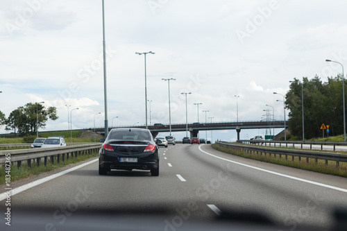 Driving a car on the highway in good weather conditions © lukszczepanski
