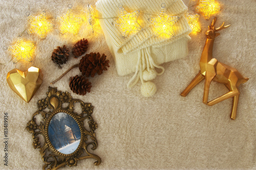 Winter concept with cozy lifestyle objects over fur carpet. Top view.