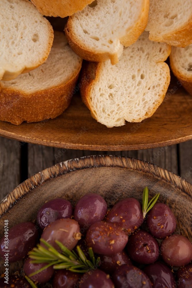 Overhead view of olives and bread in plates