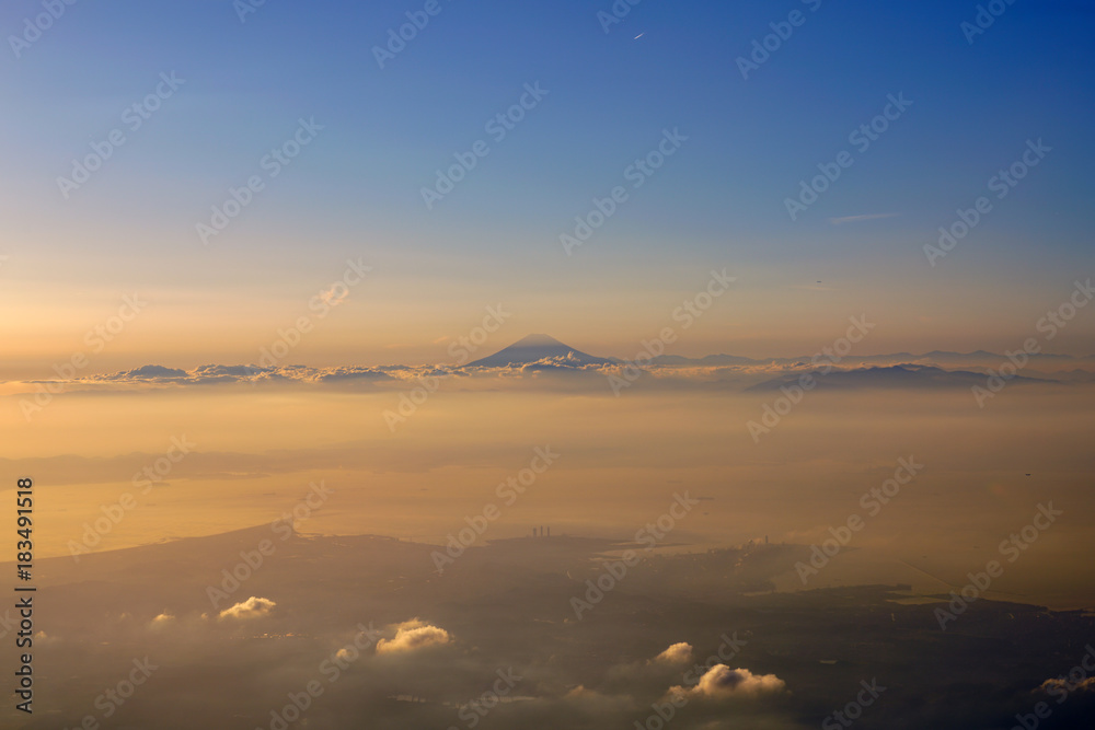 Aerial view of Japan's Mount Fuji volcano at sunset in the clouds