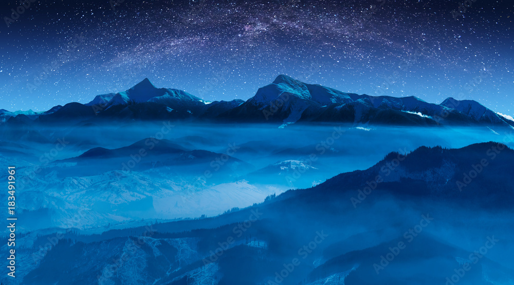 Starry sky with milky way above the high mountain ridge
