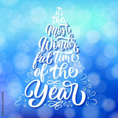 Custom lettering It's the most wonderful time of the year in Christmas fir tree silhouette illustration, on winter blue defocused background. Vector holiday poster design.