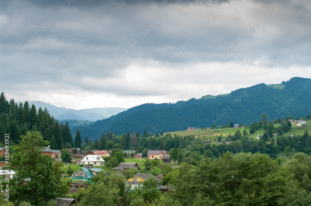 Carpathian mountains village with cloudy weather