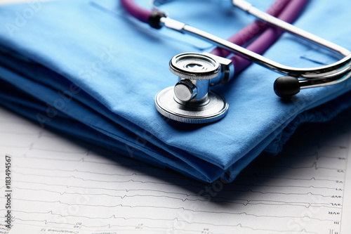 Doctor coat with medical stethoscope on the desk