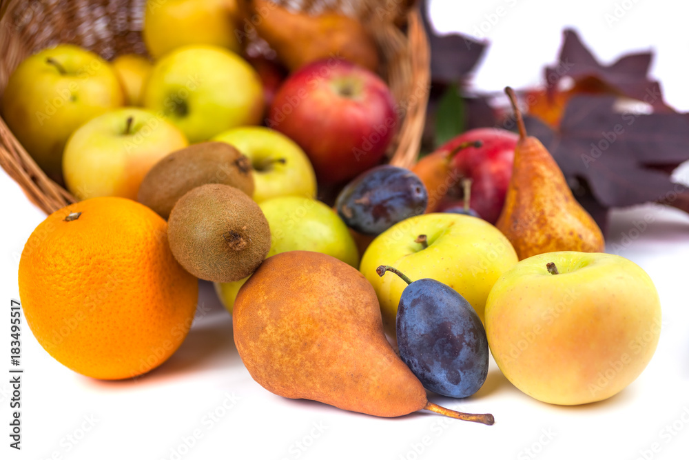 apples and other fruits in a wicker basket on a white background apples and other fruits in a wicker basket on a white background