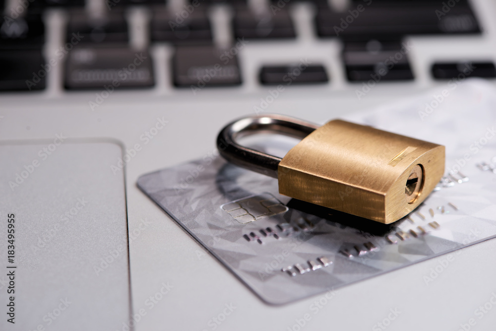 Fototapeta premium Credit cards on the keyboard with lock close up