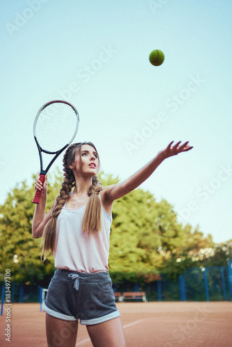 Girl in sportswear serves tennis ball © vitaliismulskyi
