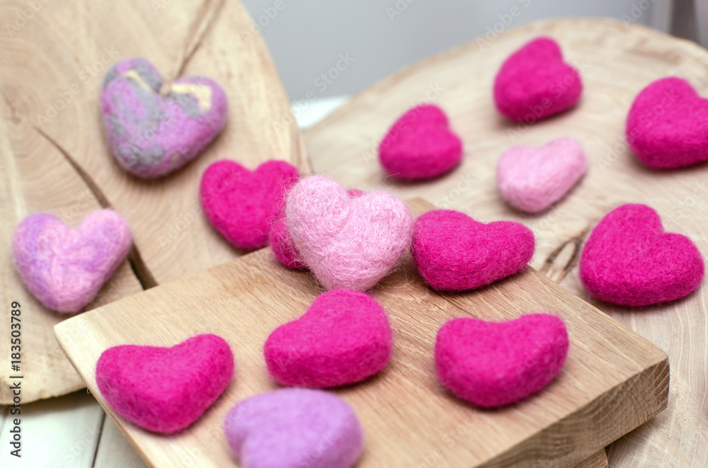 Pink little hearts on wooden surface Pink little hearts on wooden surface