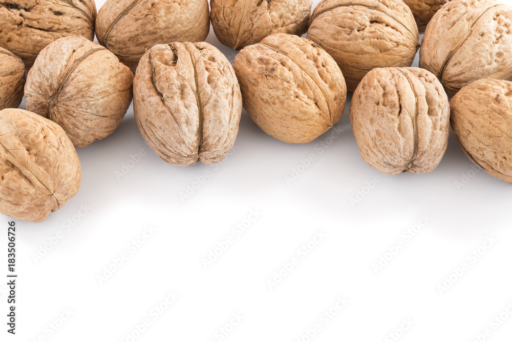 Walnuts in pile on white background with copy space Walnuts in pile on white background with copy space