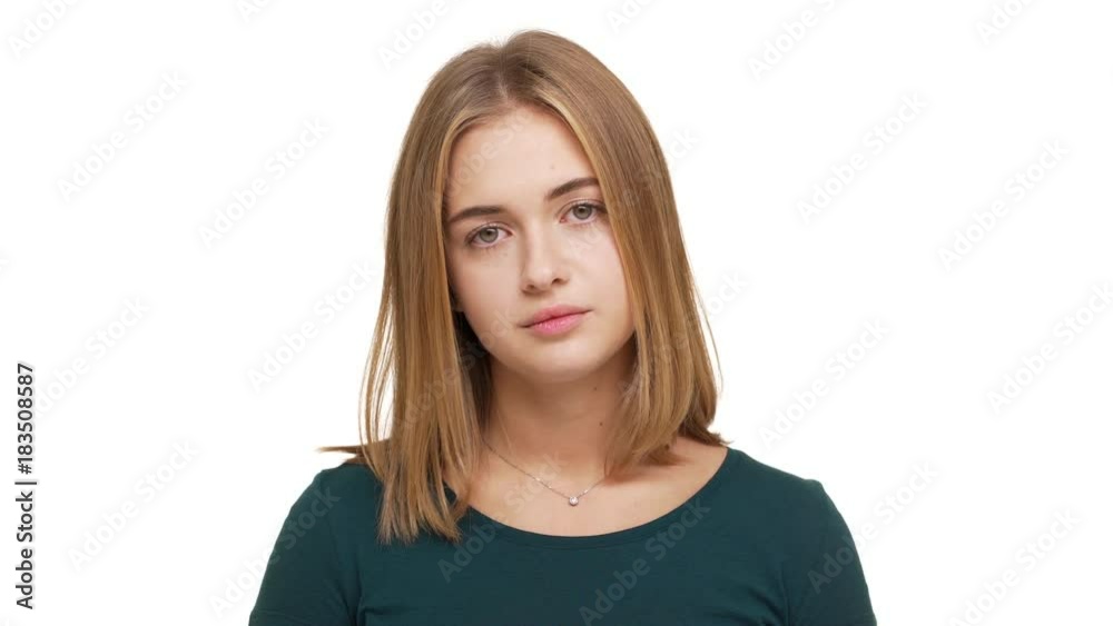 Portrait of caucasian woman looking on camera apathetically rolling her hazel eyes being sick of conversation or person isolated over white background closeup. Concept of emotions Portrait of caucasian woman looking on camera apathetically rolling her hazel eyes being sick of conversation or person isolated over white background closeup. Concept of emotions