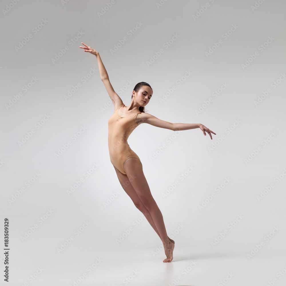 Fototapeta premium young beautiful dancer in beige swimsuit