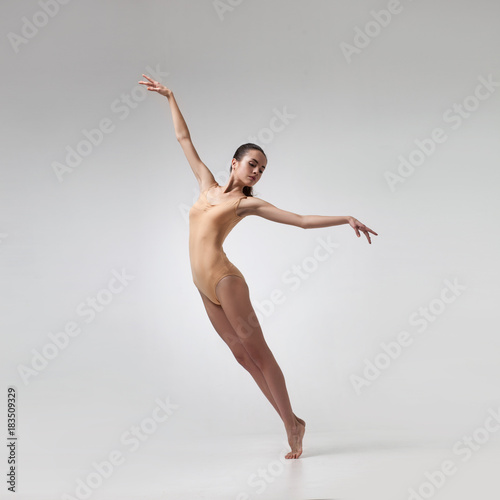 young beautiful dancer in beige swimsuit